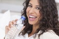 Happy Hispanic Woman Drinking Bottle of Water Royalty Free Stock Photo