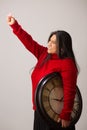 Happy Hispanic Woman Holding Clock Lifts Fist Triumphantly