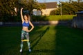 happy hispanic woman personal trainer lifting heavy kettle with a treadmill on her knees