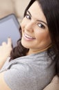 Happy Hispanic Woman Using Tablet Computer or iPad Royalty Free Stock Photo