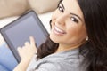 Happy Hispanic Woman Using Tablet Computer or iPad Royalty Free Stock Photo