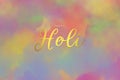 Happy Holi lettering on watercolor texture background