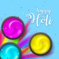 Happy HOLI. Powder on blue backdrop. Gulaal Explosion ink. Hindu, Dhulandi, Rangpanchami card. Launched dust, liquid