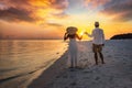 A happy holiday couple stands on a tropical beach Royalty Free Stock Photo