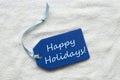 Happy Holidays On Blue Label Sand Background