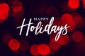 Happy Holidays Calligraphy with Red Defocused Bokeh Lights Background