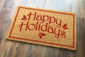 Happy Holidays Christmas Tad Welcome Mat On Wood Floor Background Royalty Free Stock Photo