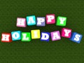 HAPPY HOLIDAYS concept from colorful toy blocks on a green grass Royalty Free Stock Photo