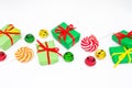 Happy holidays: gifts with lollipops and red, green, golden bells on a white background, copy space. The concept of Christmas, Royalty Free Stock Photo