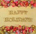 Happy Holidays golden text and Christmas decorations Royalty Free Stock Photo