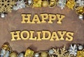 Happy holidays golden text and Christmas decorations Royalty Free Stock Photo