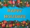 Happy holidays golden text and spruce branch and Christmas decor Royalty Free Stock Photo