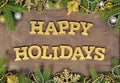 Happy holidays golden text and spruce branch and Christmas decor Royalty Free Stock Photo