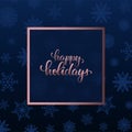 Happy holidays Hand drawn brush pen lettering in golden rose frame on blue background with snowflakes. Trendy template of Merry Royalty Free Stock Photo