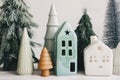 Happy holidays. Miniature cozy village, ceramic houses, wooden and handmade christmas trees. Christmas little houses and trees on