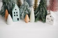 Happy holidays. Miniature cozy village, ceramic houses, wooden and handmade christmas trees. Christmas little houses and trees on