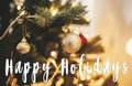 Happy Holidays text on christmas tree with ornaments,baubles, go Royalty Free Stock Photo