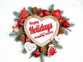 Happy Holidays and happy 2019 text with Holiday Evergreen Branches, frame in the shape of a heart Royalty Free Stock Photo