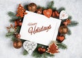 Happy Holidays Text with Holiday Evergreen Branches and photoframe New Year tree, decorations Top view, flat lay Royalty Free Stock Photo