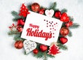 Happy Holidays Text with Holiday Evergreen Branches and photoframe New Year tree, red decorations Top view, flat lay Royalty Free Stock Photo