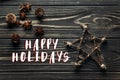 Happy holidays text sign on stylish simple star and anise and pi