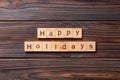 Happy Holidays word written on wood block. Happy Holidays text on cement table for your desing, concept Royalty Free Stock Photo