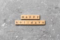 Happy Holidays word written on wood block. Happy Holidays text on cement table for your desing, concept Royalty Free Stock Photo