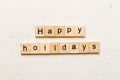 Happy Holidays word written on wood block. Happy Holidays text on cement table for your desing, concept Royalty Free Stock Photo