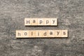 Happy Holidays word written on wood block. Happy Holidays text on cement table for your desing, concept Royalty Free Stock Photo