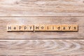 Happy Holidays word written on wood block. Happy Holidays text on wooden table for your desing, concept Royalty Free Stock Photo