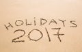 Happy Holidays 2017. Written in sand at the beach. Holiday, Christmas, New Year 2017 concept. Royalty Free Stock Photo