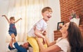 Happy is the home with laughter in it. Portrait of a happy young family enjoying playtime together at home. Royalty Free Stock Photo