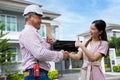 Happy homeowner stand in front of contractor and shake hand, handyman holding clipboard and after checking details before Royalty Free Stock Photo