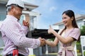 Happy homeowner stand in front of contractor and shake hand, handyman holding clipboard and after checking details before