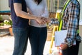 Happy homeowner stand in front of contractor and shake hand, handyman holding clipboard and after checking details before Royalty Free Stock Photo