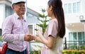 Happy homeowner stand in front of contractor and shake hand, handyman holding clipboard and after checking details before Royalty Free Stock Photo