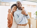 Happy homeowners. a young couple showing the keys to their new house. Royalty Free Stock Photo