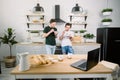 Happy homosexual boys talking each other and having breakfast. Everyday morning routine of gay couple life in kitchen at