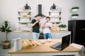 Happy homosexual boys talking each other and having breakfast. Everyday morning routine of gay couple life in kitchen at