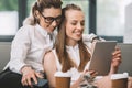 Happy homosexual couple using digital tablet in cafe Royalty Free Stock Photo