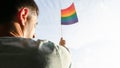 Happy Homosexual guy raised rainbow flag to the society for the freedom civil right and support the sexual liberty and identity in