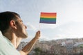 Happy Homosexual guy raised rainbow flag to the society for the freedom civil right and support the sexual liberty and identity in