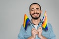 Happy homosexual man holding lgbt flags