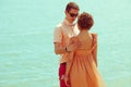 Happy honeymoon concept. Portrait of couple of young happy married hipsters in trendy clothes standing together on the beach. Royalty Free Stock Photo