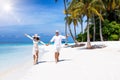 Couple walks down a tropical beach in the Maldives islands Royalty Free Stock Photo