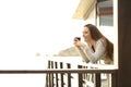 Happy hotel guest relaxing drinking coffee