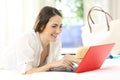 Hotel guest using a laptop in a room on summer holidays Royalty Free Stock Photo