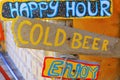Happy hour colorful sign board with cold beer and having fun
