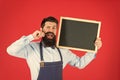 Happy hours bar. Man bearded bartender or cook in apron hold blank chalkboard. Price list concept. Hipster bartender