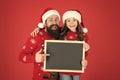 Happy hours concept. Santa claus. Dad and small girl showing chalkboard. Christmas wishes. Father daughter blackboard